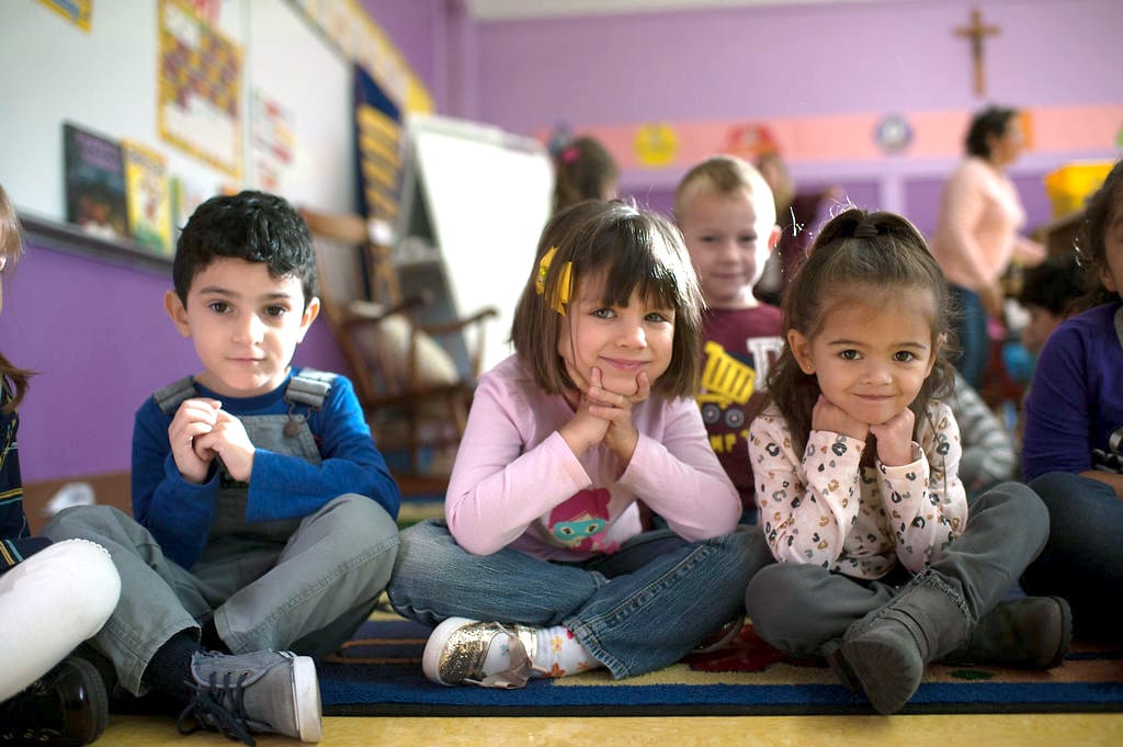 Kindergarten children smiling at the camera