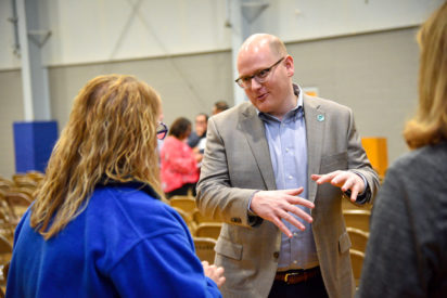 Empower CEO, Anthony Holter, talking to a woman at a school event