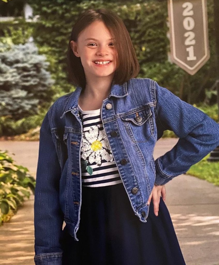 Young girl in a jean jacket smiling